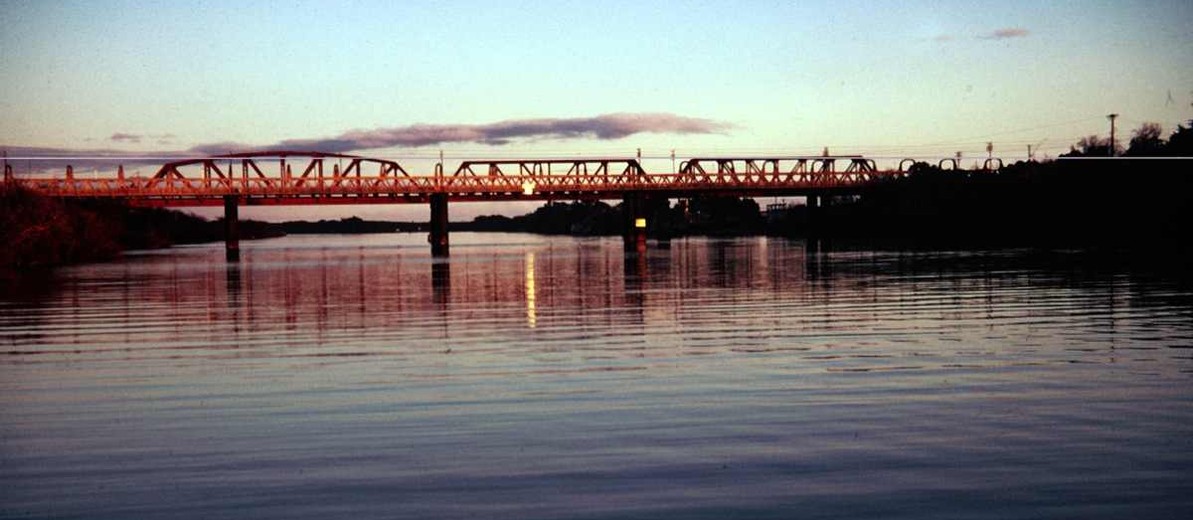 Image: bridge over river at sunset