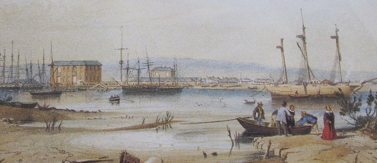 Image: A muddy riverbank and river with several sailing ships at anchor just offshore. A small group of people alight from a rowboat in the foreground