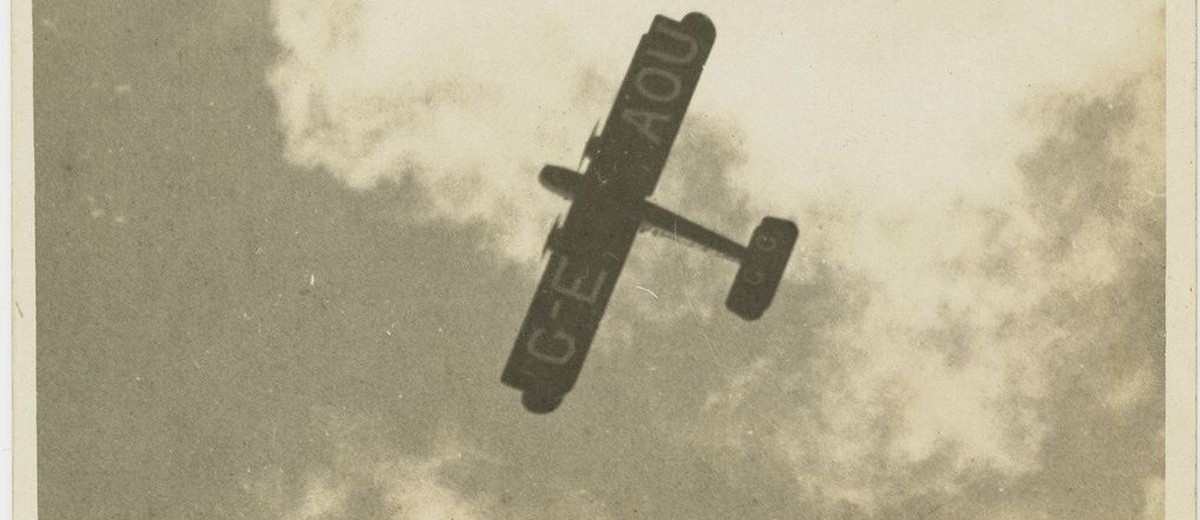 Image: underside of plane seen flying in clouds