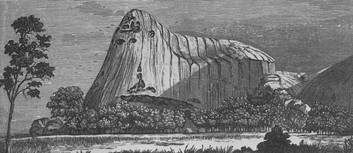Image: A lithograph of a large stone edifice with a conical peak at one end. A banner beneath the illustration features the words ‘Ayers Rock, Central Australia’  