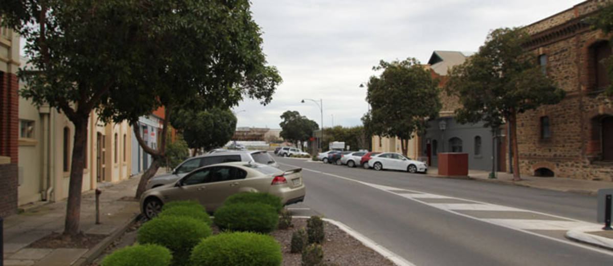 Bitumen roadway with old stone and brick buildings either side