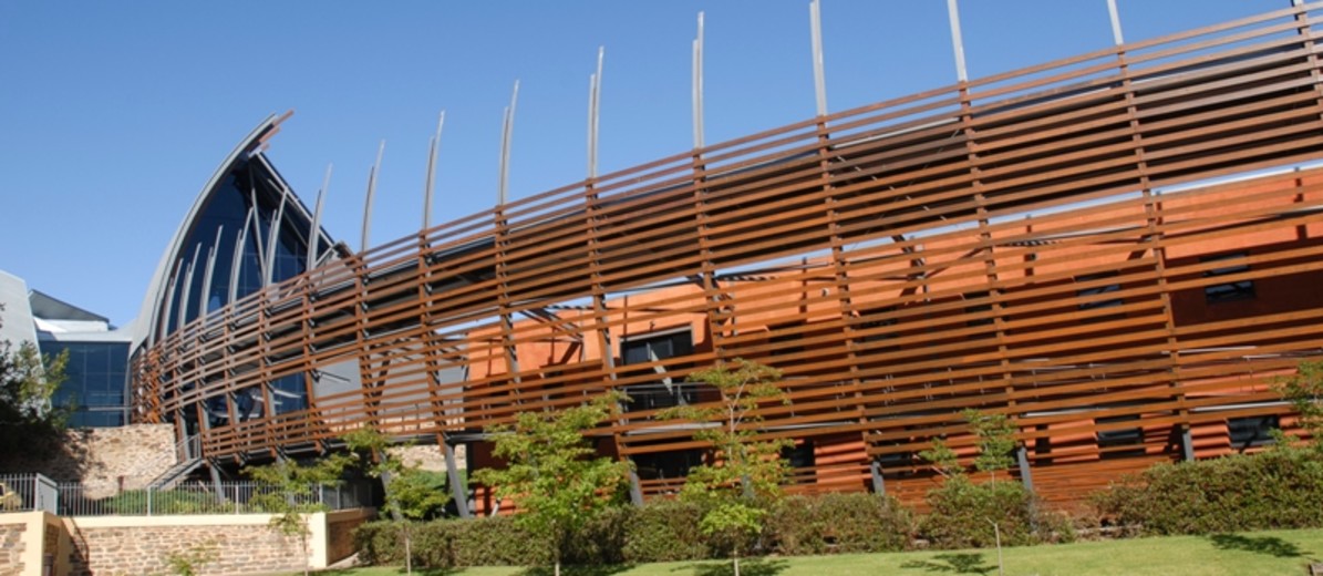 Image: Large curved building front clad in wooden slats