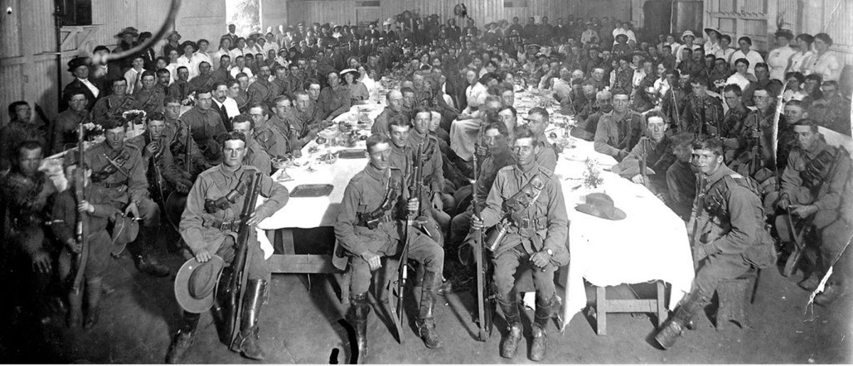 Image: large group of men in army uniform seated at tables in hall