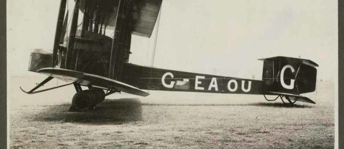 Image: black and white photo of bi-plane on the ground