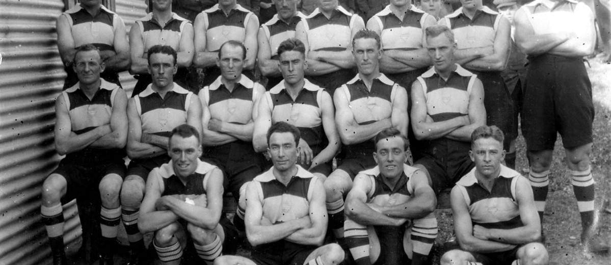 Image: A group of young Caucasian males in 1920s-era Australian Rules Football uniforms pose for a photograph