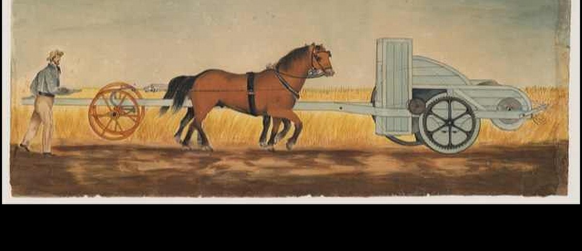 Image: A hand-drawn and coloured picture of a man in early 19th-century attire operating a machine for reaping wheat. The machine is attached to two harnessed horses, who are pushing it through a wheat crop