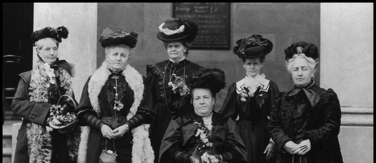 Image: photo of six women wearing black hats and dresses