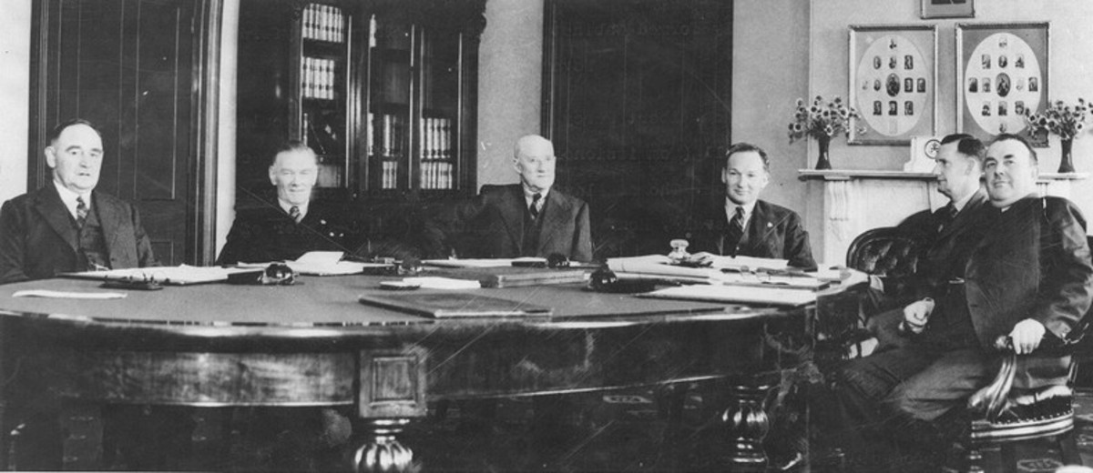 Image: group of men sitting around long table