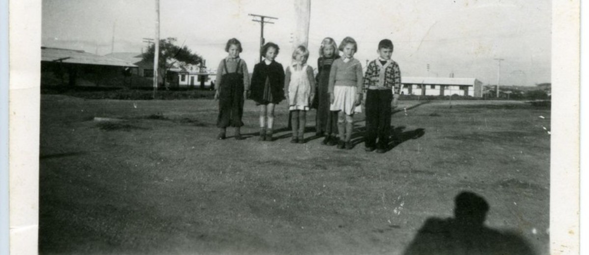 Image: group of children with buildings in background 