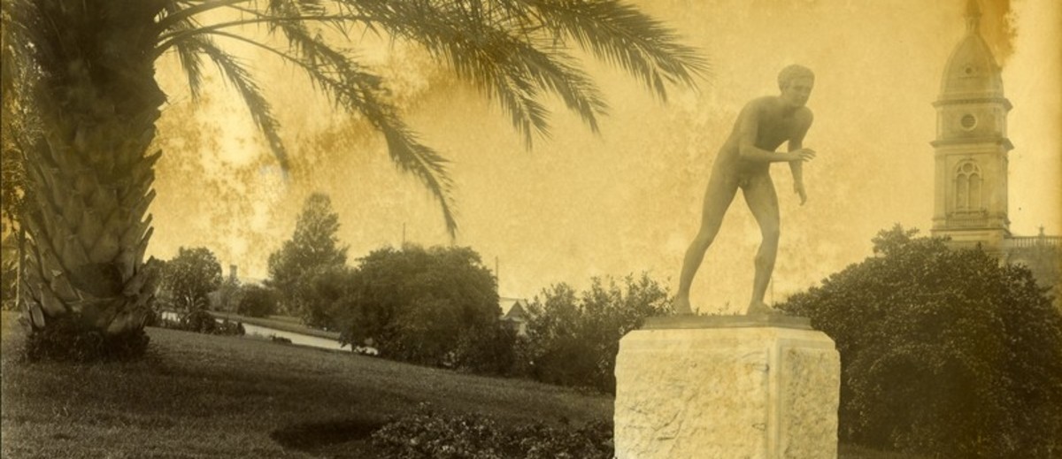 Image: sepia toned photo of statue of naked boy in running pose in a park