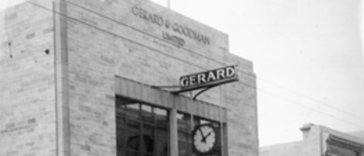 Image: Storefront featuring clock on main street. Sign reads 'Gerard and Goodman Limited'