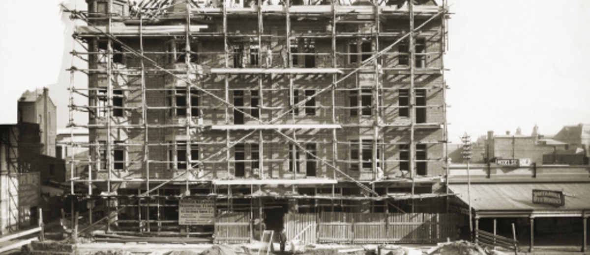 First stage of Ruthven Mansions under construction, surrounded by scaffolding and piles of builders' sand on Pulteney Street