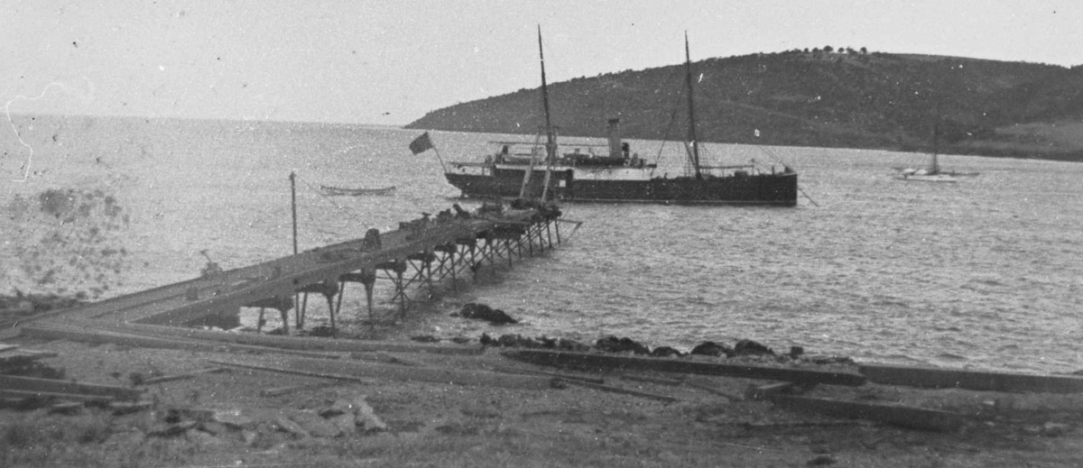 Image: boat in water near jetty on island
