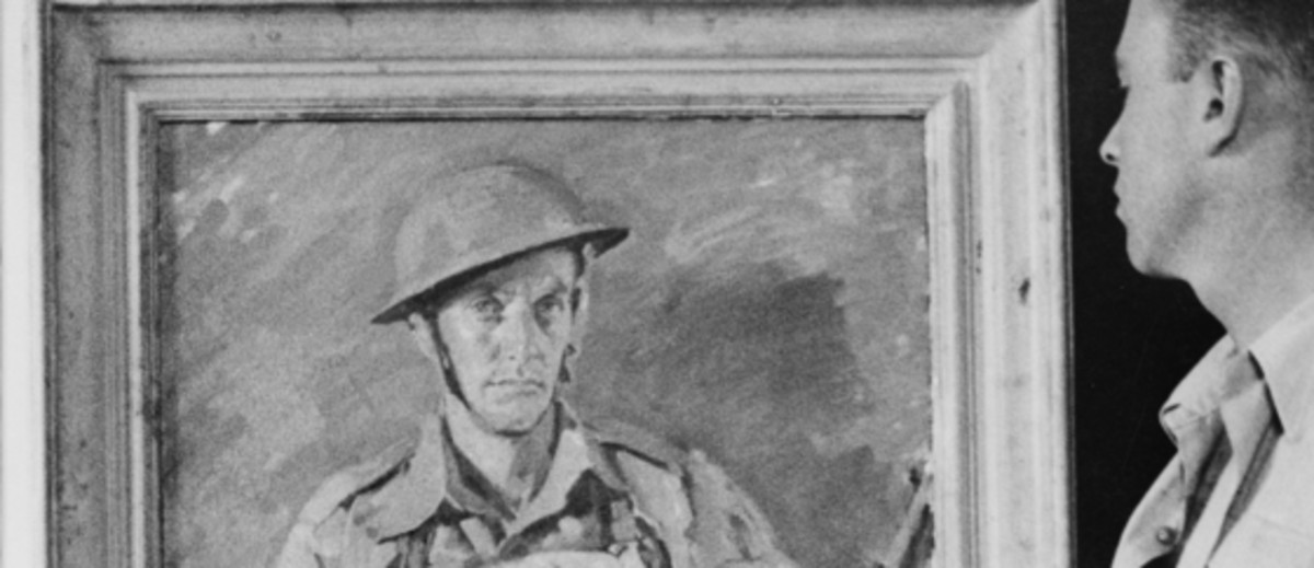 Image: A man standing holding a paintbrush and a cloth, looking at a framed painting of a soldier, the painting is on an easel