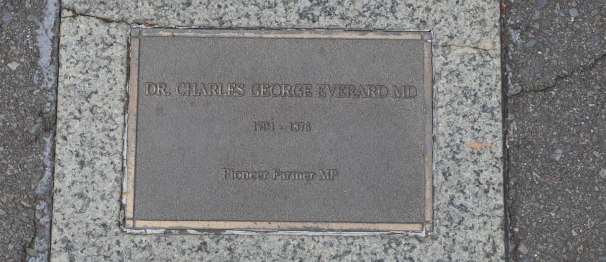 Bronze plaque set in pavement, inscribed with information about Dr Charles George Everard
