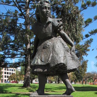 Image: Bronze statue of girl on sandstone plinth inscribed "ALICE for the children from Josephine and Norman Lewis 1962"