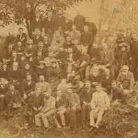 Image: a group of people gathered by a tree in a park