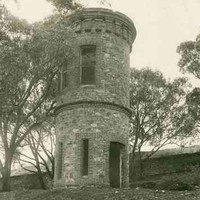 Image: Two story round stone tower on the side of a hill
