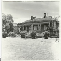 Image: Black and white photograph of the Anlaby house front lawn. House features mullioned windows, and deep set veranda supported by doric columns