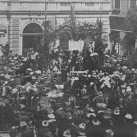 Image: crowd of people in front of stone building