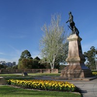 Image: bronze sculpture with city in background