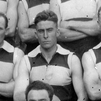 Image: A group of young Caucasian males in 1920s-era Australian Rules Football uniforms pose for a photograph