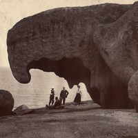 Image: people in front of large rock formation