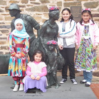 Image: children standing on sculpture