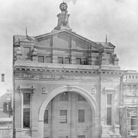 Image: large building with ornate arched entrance