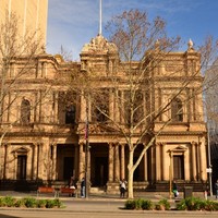 Sandstone fronted building featuring a number of Italianate pillars