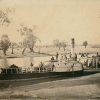Image: paddle steamer with a number of people standing on top
