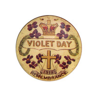Image: small circular badge with violets, cross and crown pictures