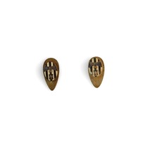 Image: two small metal pins in teardrop shape with black and white stripes