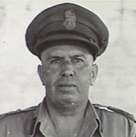 Image: Photographic head-and-shoulders portrait of a middle-aged Caucasian man in the uniform of a high-ranking Australian Army officer