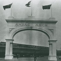 Image: Stone archway with three flags flying on top