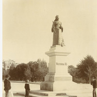 Image: people standing next to statue of woman