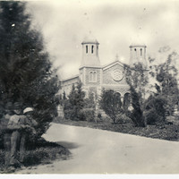 Image: View of a group of children in garden with church in the background