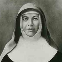 Image: A portrait of a young woman wearing a nun’s habit. She is holding a bible and a crucifix