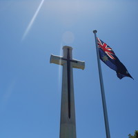 Image: Australian flag in front of cross monument, 2015.