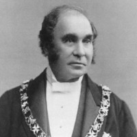Image: Black and white photograph of man wearing formal clothes and livery collar