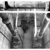 Image: view from above of man amongst large pipes