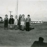 Image: group of children with buildings in background 