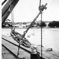Image: large metal anchor suspended over jetty