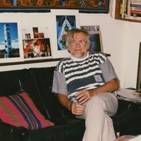 Image: man sitting in living room