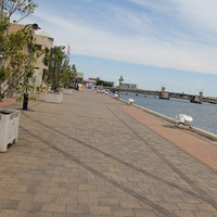 Paved waterfront with bollards along wharf