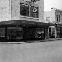 Image: Storefront featuring clock on main street. Sign reads 'Gerard and Goodman Limited'