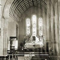 Image: View of church interior, including altar and stained glass windows
