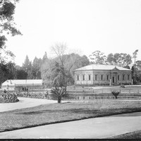 Image: grass and pond with Greek Revival style building in the background