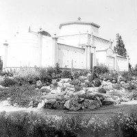 Image: Glasshouse surrounded by a rockery garden