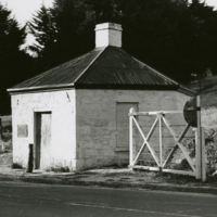 Image: Toll house and gate next to modern road